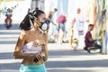 Girl graffiti artist with spray cans and Mask