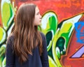 Girl by a graffiti wall Royalty Free Stock Photo