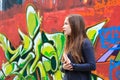 Girl by a grafitti wall Royalty Free Stock Photo