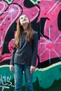 Girl by a grafitti wall Royalty Free Stock Photo