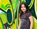 Girl by a grafitti wall Royalty Free Stock Photo