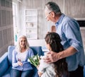 The girl and grandfather giving flowers to a grandmother. Royalty Free Stock Photo