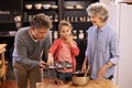 Girl, grandparents and baking with cupcakes, kitchen and bonding together. Mature couple, smile and child with happiness Royalty Free Stock Photo