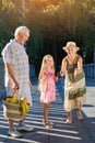 Girl with grandparents, bubble blower. Royalty Free Stock Photo