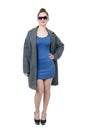 Girl in gray coat and blue dress in heels on white background