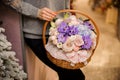 Girl holds a basket with purple orchids, pink roses and blue hydrangea Royalty Free Stock Photo