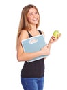 Girl with green apple and personal scale Royalty Free Stock Photo