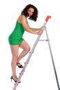 Girl in green dress going up on ladder. Royalty Free Stock Photo
