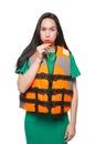 Girl in a green dress and in a life jacket blowing a whistle, giving a command or a danger signal, safety and protection concept, Royalty Free Stock Photo