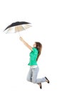 Girl in green shirt and gray jeans pants with umbrella jumping Royalty Free Stock Photo