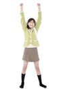 Girl in green sweater and skort standing with arms rasied, happy