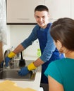 Girl in green watching plumbers work Royalty Free Stock Photo