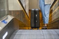 Girl is groing up on escalator with suitcase during holiday trip at airport. Traveling, transfer, waiting at airport