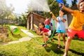 Children In the middle of water gun fight fun Royalty Free Stock Photo