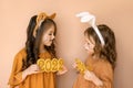 Girl in the guise of a tiger with the figure of the outgoing year 2022 and a baby dressed up as a hare, a symbol of the new year 2