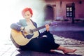 Girl with the guitar on the background of the Cracow