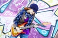 Girl with guitar and graffiti