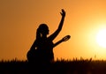 Girl with guitar at sunset Royalty Free Stock Photo