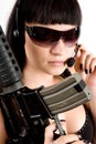 Girl with gun and headphones Royalty Free Stock Photo