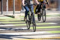 The girl and the guy crosses the road with tram rails on bicycles in specially marked passage