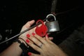 A young girl and a young boy in green forest hands on the lock