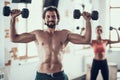 Girl And Guy In Gym Doing Dumbbells Exercises