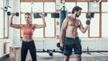 Girl And Guy In Gym Doing Dumbbells Exercises