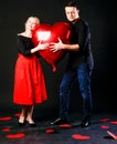 A girl and a guy hold a heart ball inflatable valentine red, board, on the floor hearts married space. inspiration