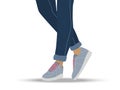 Girl or guy legs wearing sneakers and jeans. Casual comfortable shoes and clothing. Gray Sneakers for walks and sports Royalty Free Stock Photo