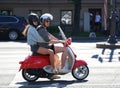 Girl with a guy on a red scooter, St. Isaac`s Square, St. Petersburg, Russia, June 2022