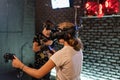 A girl and a guy in virtual reality helmets with joysticks play computer 3D games