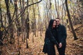 The girl and the guy are walking in the autumn forest Royalty Free Stock Photo