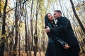 The girl and the guy are walking in the autumn forest Royalty Free Stock Photo