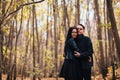 The girl and the guy are walking in the autumn forest Royalty Free Stock Photo