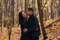 The girl and the guy are walking in the autumn forest Royalty Free Stock Photo