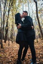 The girl and the guy are walking in the autumn forest Royalty Free Stock Photo