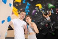 Girl gym coach and teen client standing in fitness room discussing possible options climbing Royalty Free Stock Photo