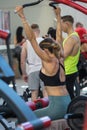Girl at Gym doing Shoulders Weightlifting Exercises: Fitness Workout on Bench
