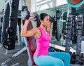 Girl at gym seated dumbbell shoulder press Royalty Free Stock Photo