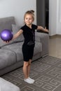 Girl gymnast performs exercises with the ball. Children`s sports, athletics, rhythmic gymnastics concept Royalty Free Stock Photo