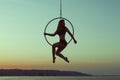 Girl gymnast sits on an acrobatic ring. Royalty Free Stock Photo