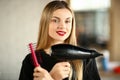 Girl Hairdresser Crossed Hands with Comb and Dryer Royalty Free Stock Photo