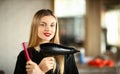 Girl Hairdresser Crossed Hands with Comb and Dryer Royalty Free Stock Photo