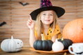 Girl in Halloween costume looking at camera, smiling and pointing up with her finger. Royalty Free Stock Photo