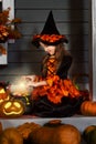 Girl in halloween costume with magic pot Royalty Free Stock Photo