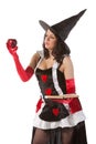 Girl in Halloween witch bewitches an apple Royalty Free Stock Photo