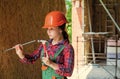 girl hammering a nail. carpentry and woodworking concept. teen child using hammer tool. building and repair tools Royalty Free Stock Photo