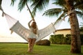 Girl in a hammock bother palm trees enjoying a tropical vacation