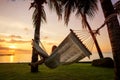 Girl in a hammock bother palm trees enjoying a tropical vacation