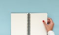Girl hand holding a blank notebook. Inspirational image to plan resolutions and aspirations. Copy space